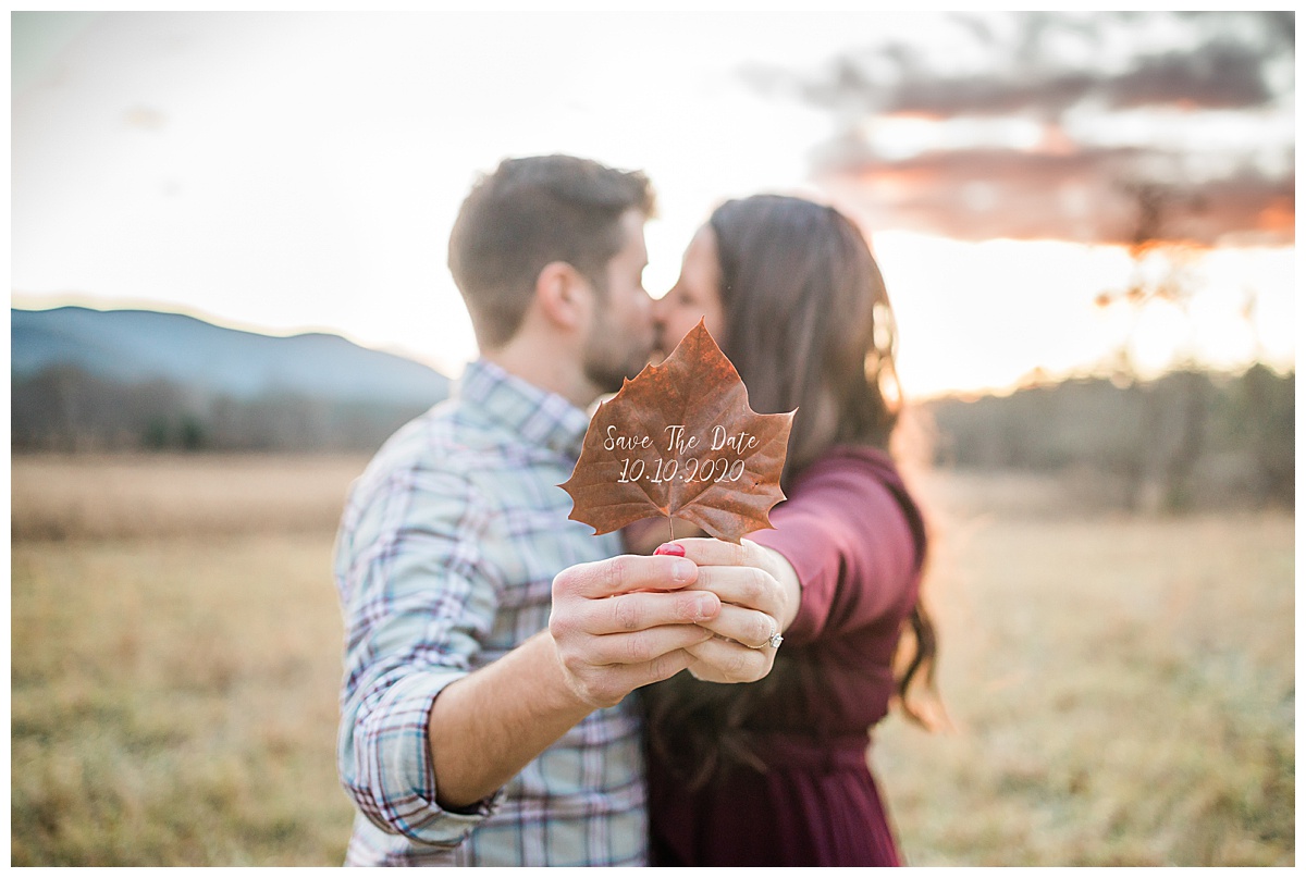 Couple sharing a sweet moment in a Cades Cove field at sunset
