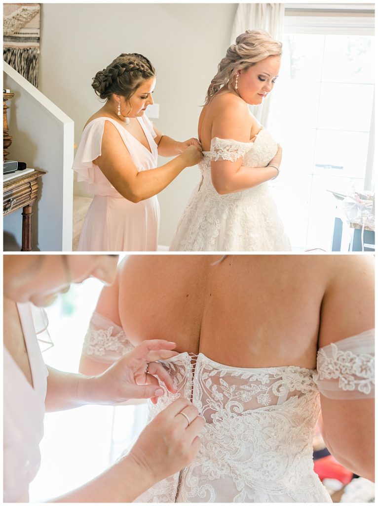 Bride's sister buttoning up beautiful wedding gown