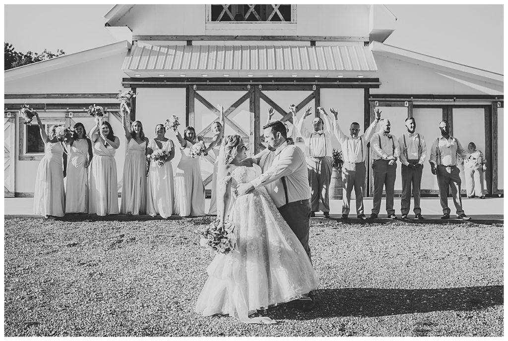 Wedding party photos in front of The White Barn at Cruze Farms