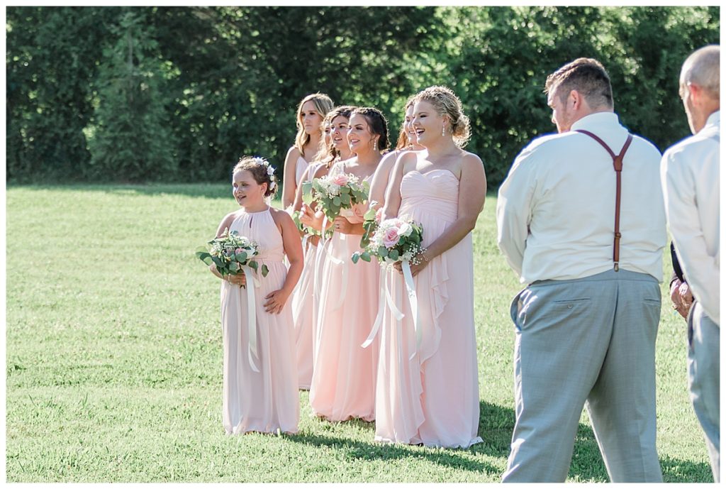 bridal party waiting for flower girls to walk down isle