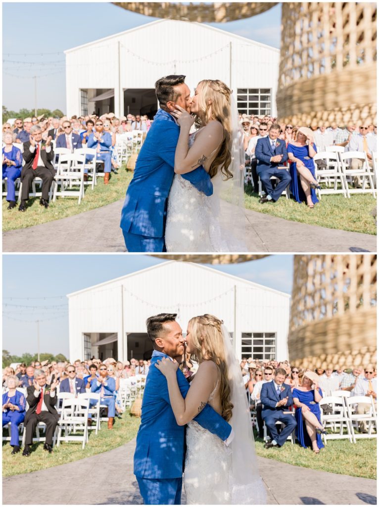 newlywed first kiss with guests in the background