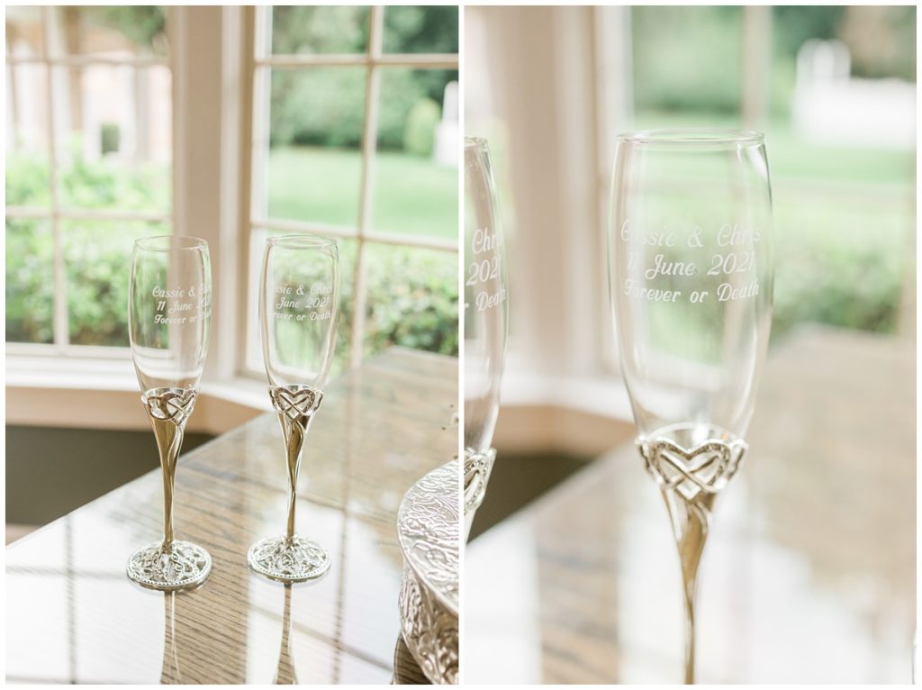 detail shot of champagne wedding glasses that are white silver with heart details