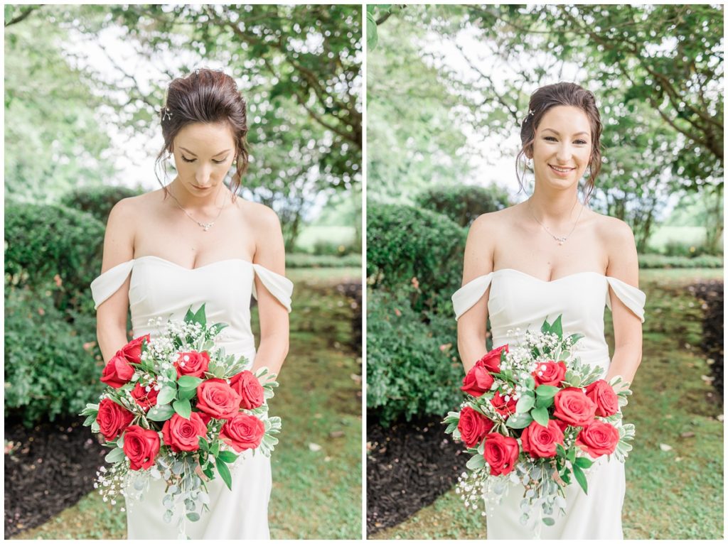 bride in the gardens at Christopher place smiling with her bouquet of red roses on her wedding day in the Smokey Mountains