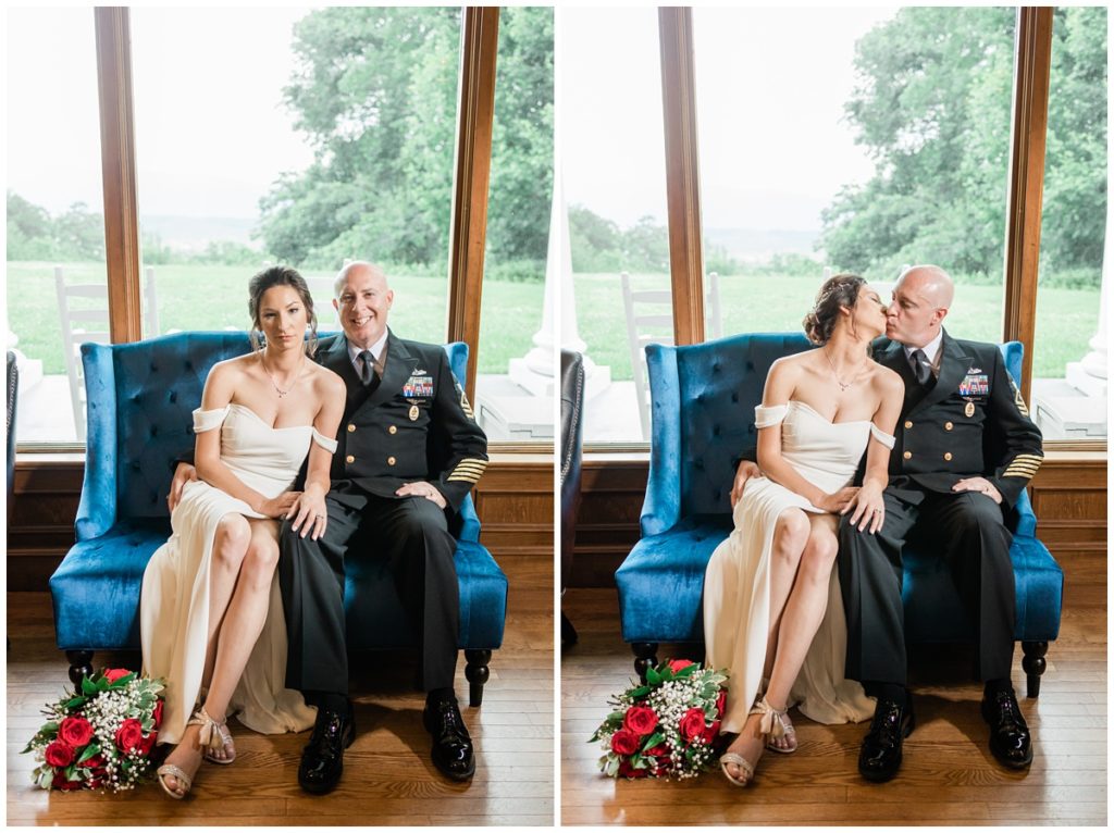 bride and groom sitting on a velvet blue chair at Christopher Place for their Military Elopement with the red rose bouquet sitting on the floor next to the bride and the Smokies in the window frame behind them