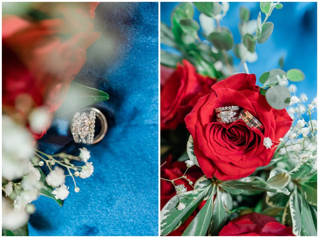 detail shot of wedding rings on a velvet blue background and a red rose with babies breathe 