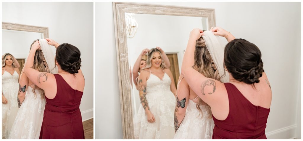 bridesmaid putting veil on bride in bridal suite