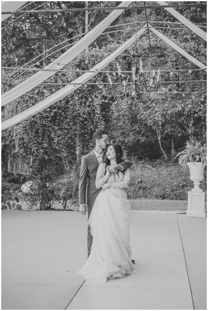 bride and groom dancing photo in black and white