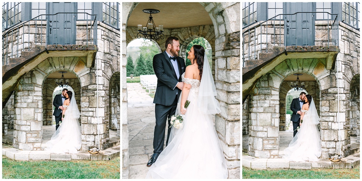 couples portrait under historical rock structure of the kincaid house