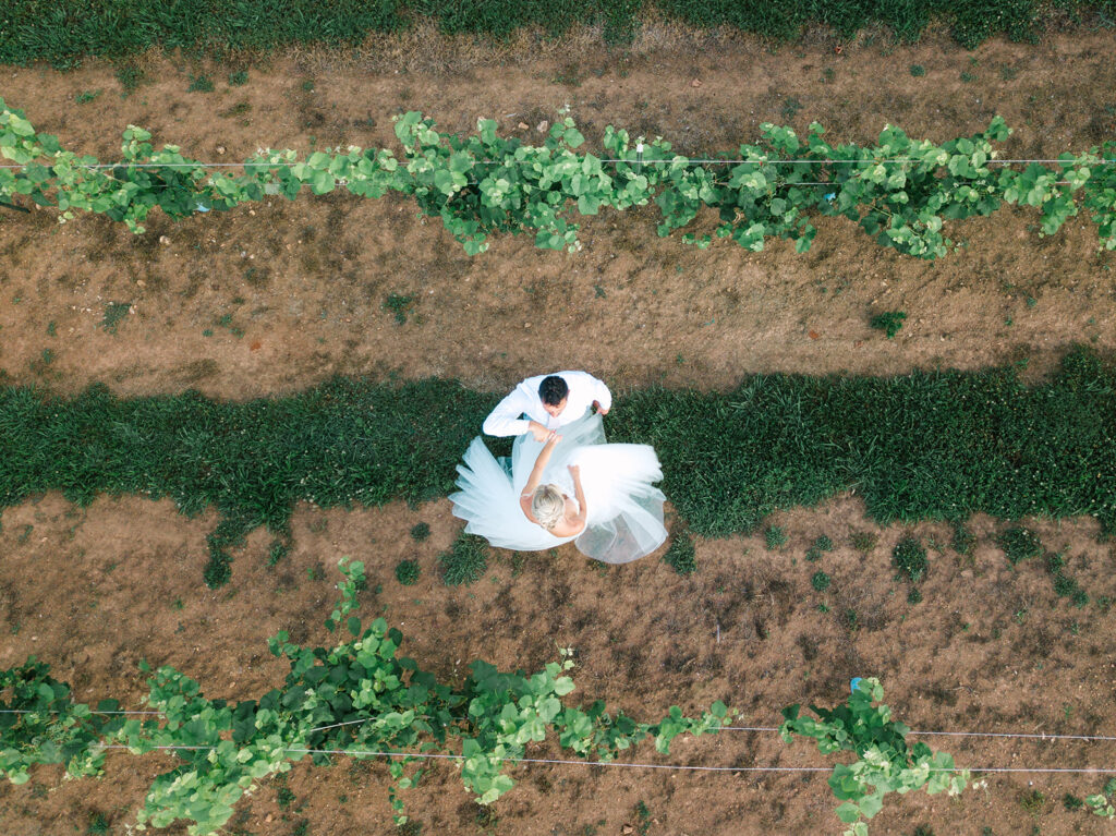 newlywed drone dancing photo in the vineyards at wedding venue