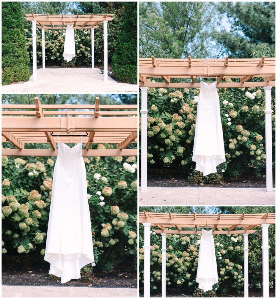 wedding dress hanging at the outdoor ceremony site of lenoir city wedding venue