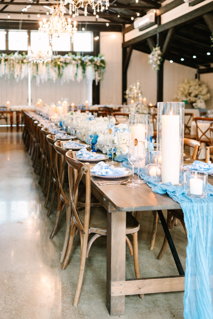 wedding reception space inside hidden springs venue featuring blue and white accents in a rustic setting