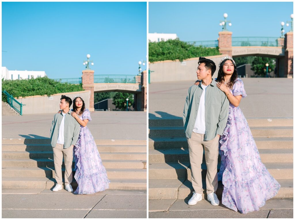 couple standing on the stairs in front of harriet island regional park sign