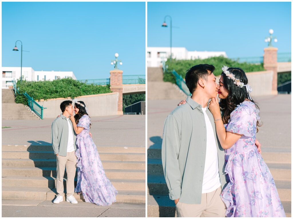 couple standing on the stairs in front of harriet island regional park sign