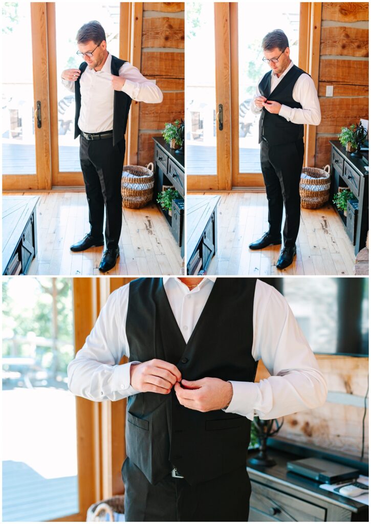 groom putting on his vest and buttoning it
