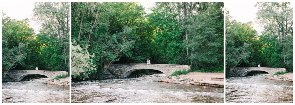 couple standing far away on minnehaha falls bridge