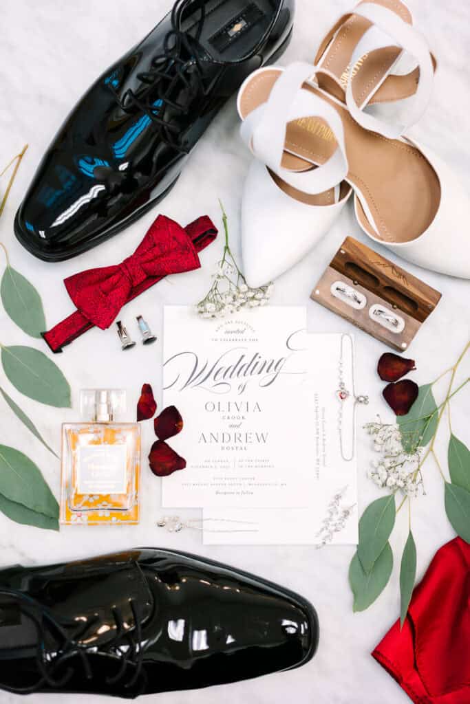 Olivia + Andrew Wedding Fall wedding invitation suite with rings, perfume, shoes, and red details