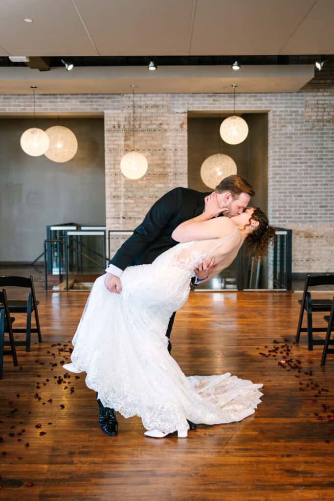 Olivia + Andrew Wedding Groom dipping the bride during a playful indoor portrait