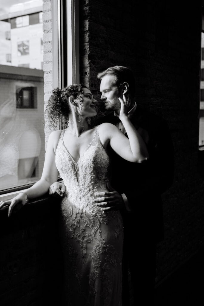 Olivia + Andrew Wedding Black and white bridal portrait beside a softly lit window