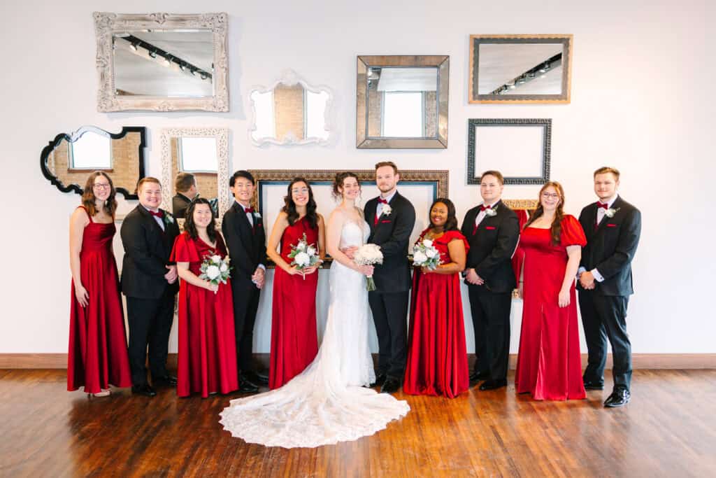 Olivia + Andrew Wedding Full wedding party portrait with red dresses and black suits