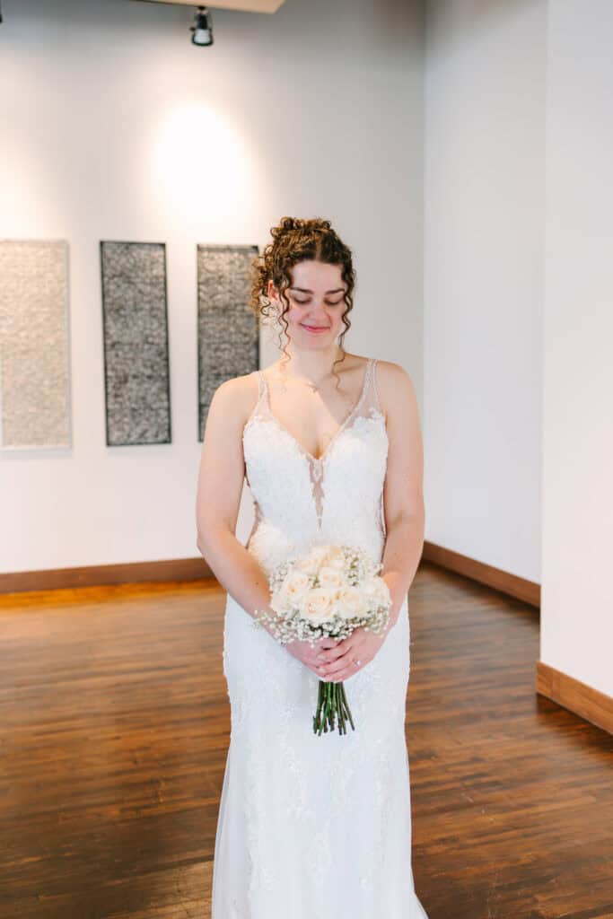 Olivia + Andrew Wedding Bride holding a white bouquet during a simple indoor bridal portrait