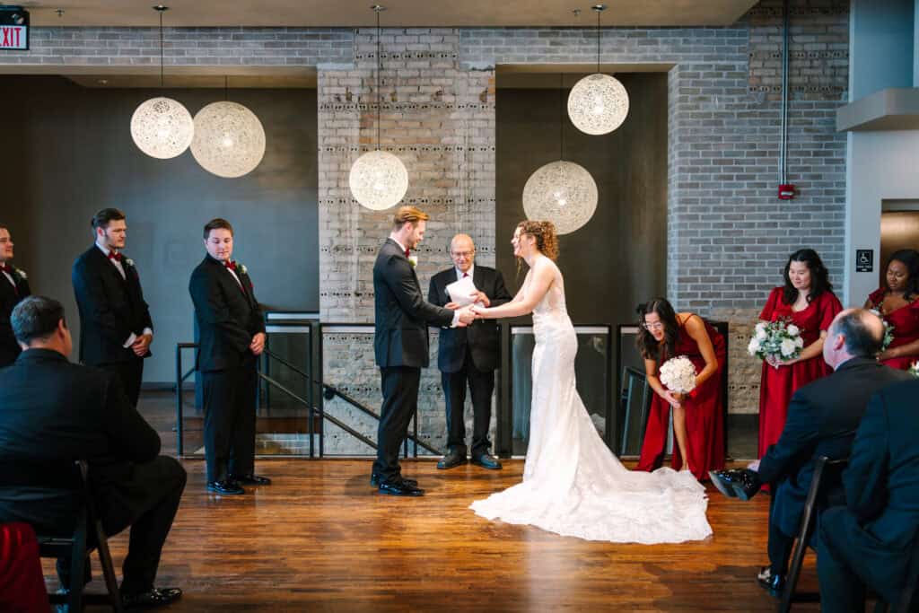 Olivia + Andrew Wedding Bride joining the groom at the ceremony beneath hanging globe lights