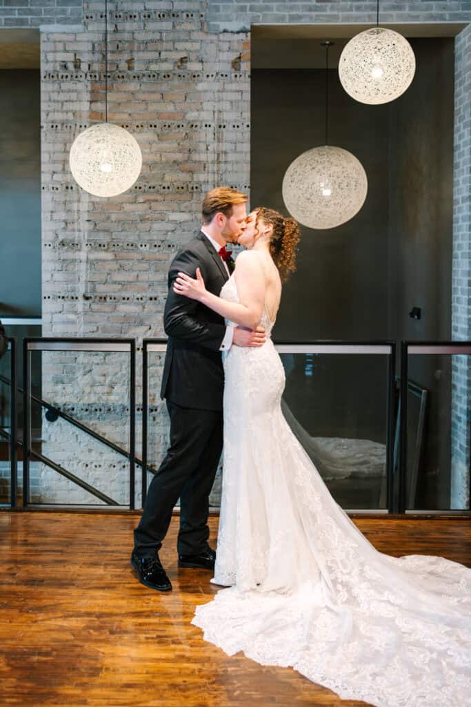Olivia + Andrew Wedding Newlyweds embracing after their indoor wedding ceremony