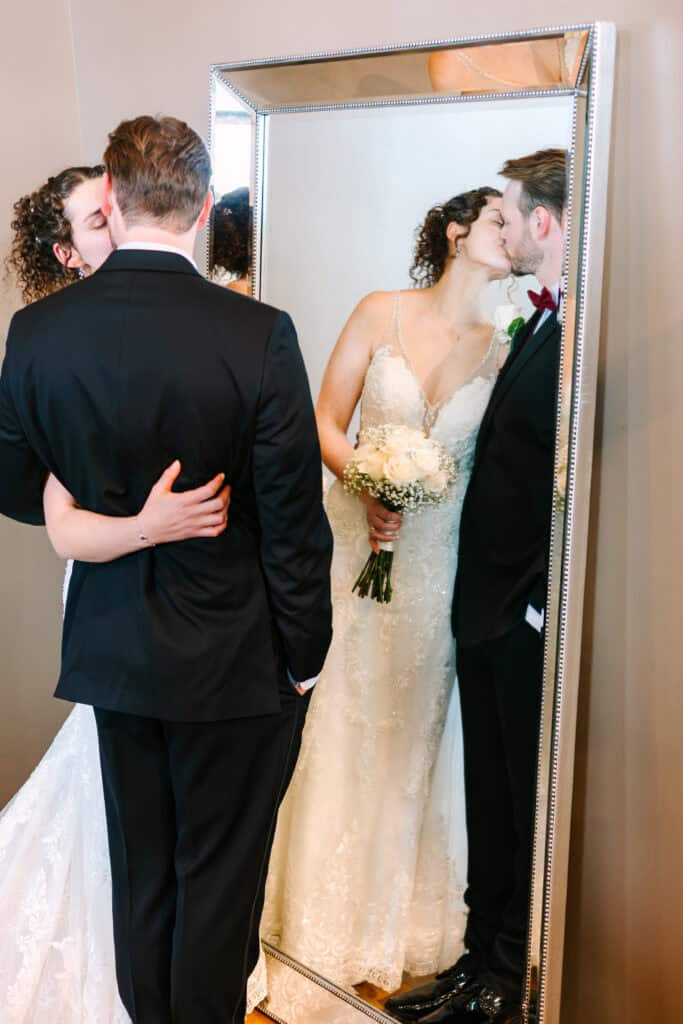 Olivia + Andrew Wedding Bride and groom embracing in a doorway during wedding portraits