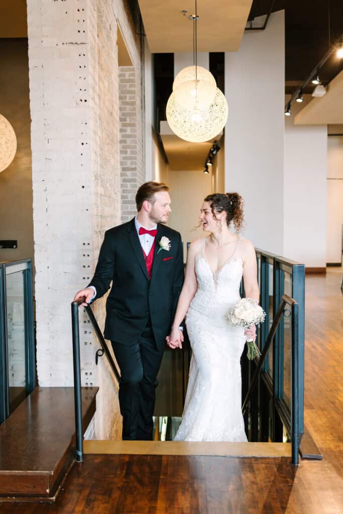Olivia + Andrew Wedding Bride and groom standing together on an indoor staircase