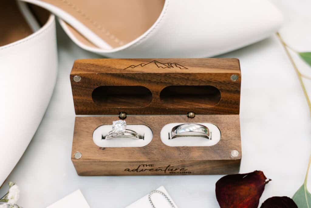 Olivia + Andrew Wedding Wedding rings displayed in an open wooden ring box