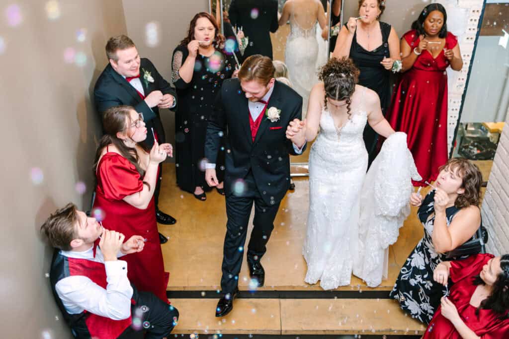 Olivia + Andrew Wedding Newlyweds running through a cheering crowd during their reception exit