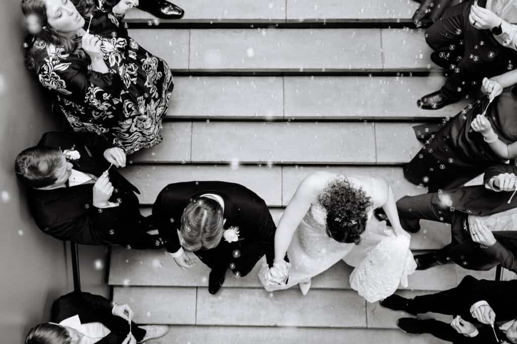 Olivia + Andrew Wedding Black and white overhead portrait of the newlyweds seated on a staircase