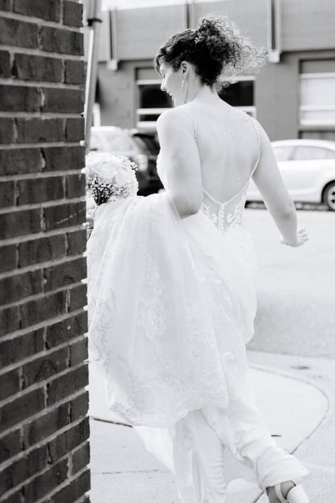 Olivia + Andrew Wedding Close view of the bride's lace wedding gown and pearl bracelet