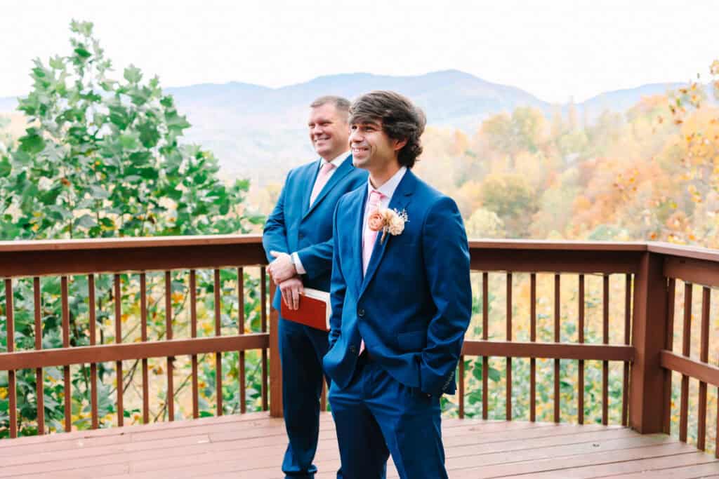 Groom smiling as he watches the bride arrive at their microwedding ceremony