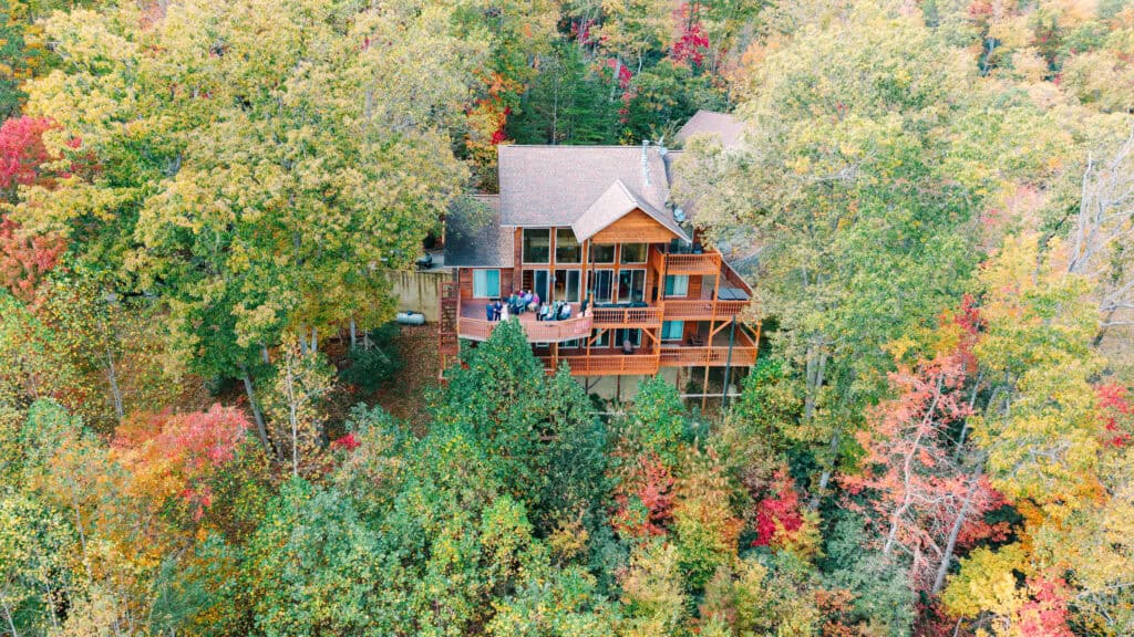 Log cabin surrounded by colorful fall trees in the Smoky Mountains