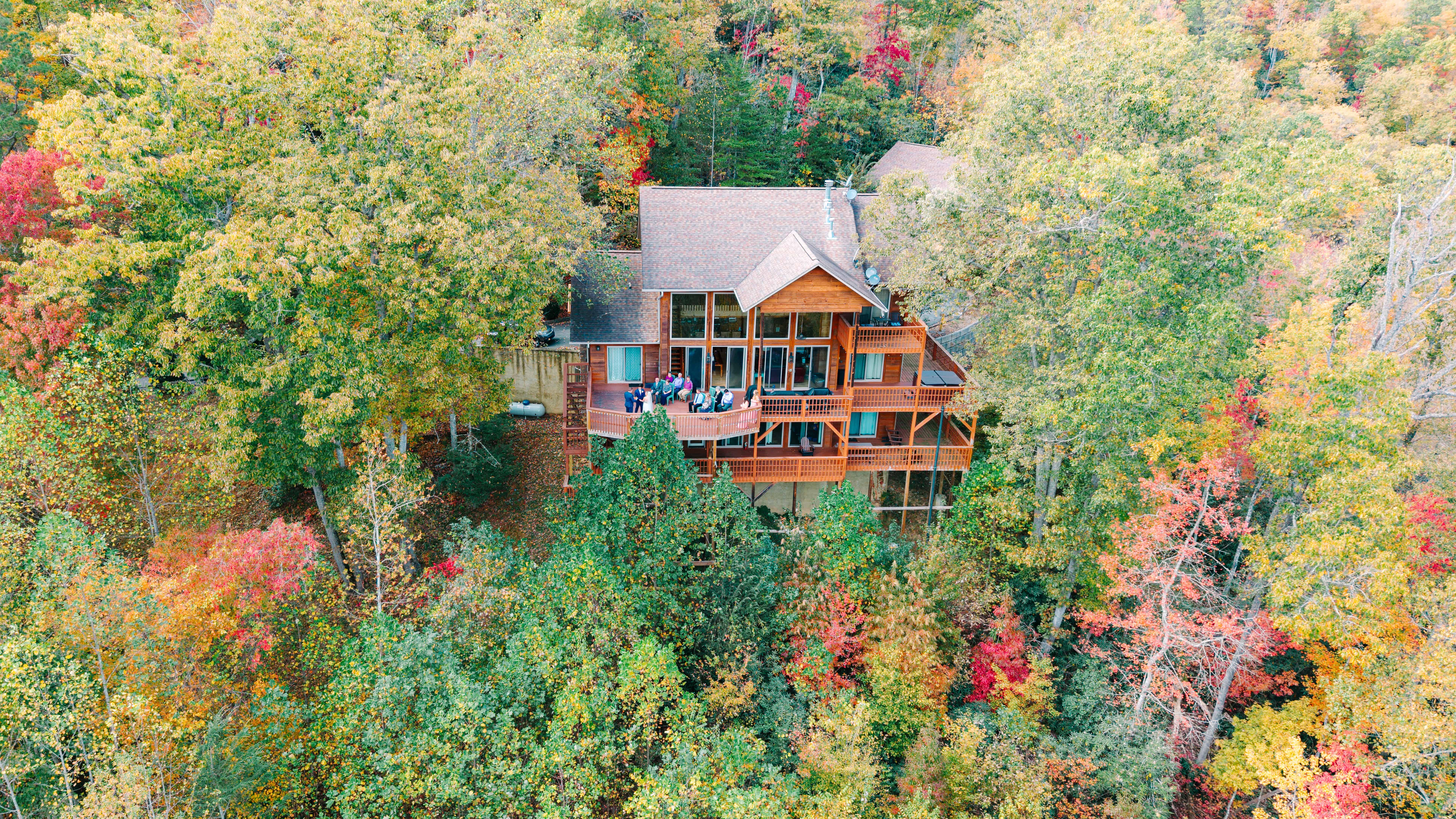 Log cabin surrounded by colorful fall trees in the Smoky Mountains
