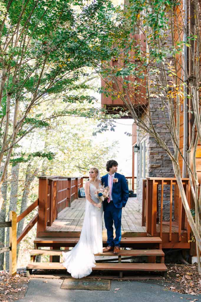 Bride and groom holding hands outside their Smoky Mountain cabin