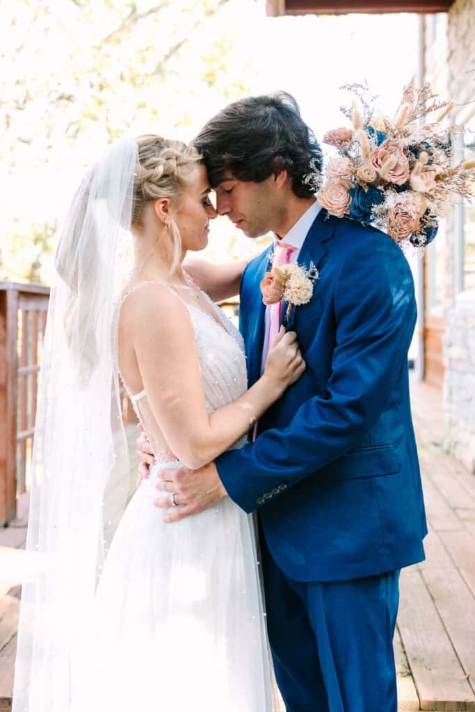 Close-up of the bride and groom embracing beside their cabin