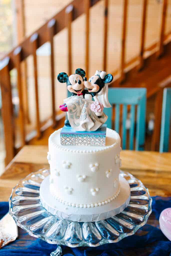 Personalized bride, groom, and dog cake topper on a white wedding cake