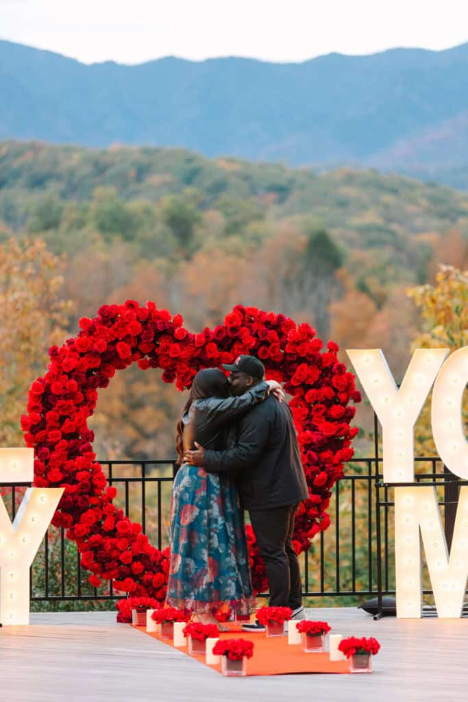 Bobby + Alyssa Proposal Newly engaged couple hugging after a surprise mountain proposal