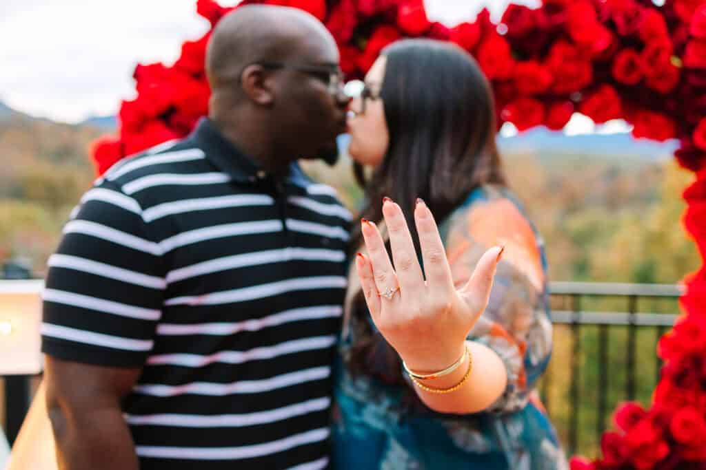 Bobby + Alyssa Proposal Engaged couple kissing while the woman shows her new ring