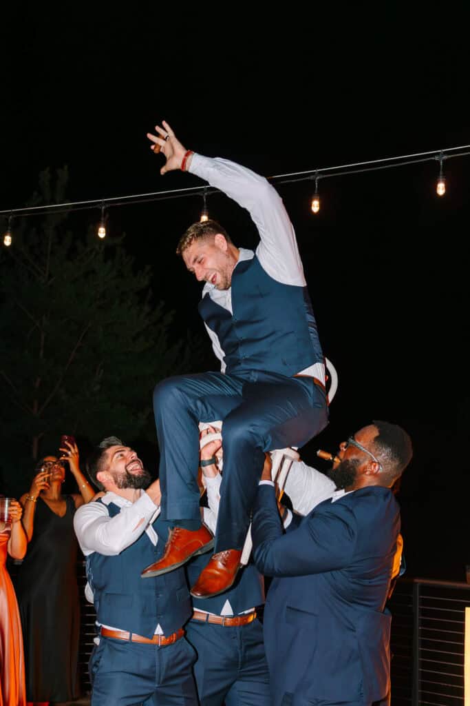 Lauren + Connor Wedding Groomsmen lift the groom above the dance floor
