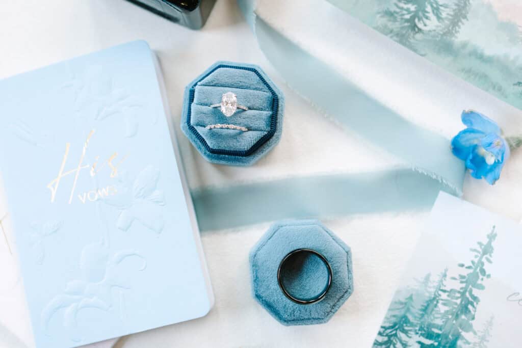 Lauren + Connor Wedding Hexagonal ring box and blue wax seal on pale wedding stationery