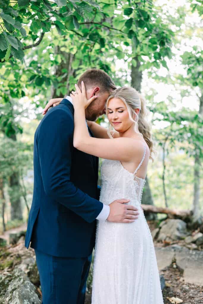 Lauren + Connor Wedding Close-up portrait of the bride and groom embracing in the woods