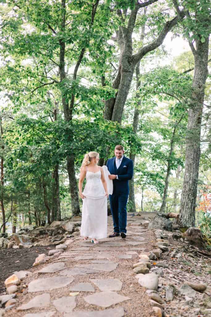 Lauren + Connor Wedding Bride and groom walk across the boulders hand in hand