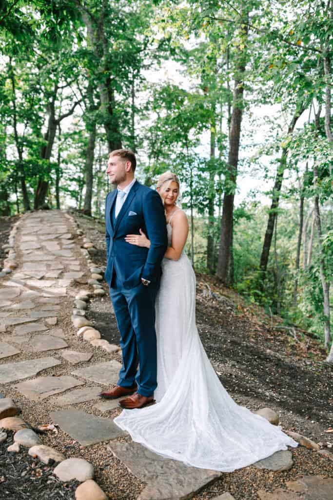 Lauren + Connor Wedding Groom faces the camera while the bride embraces him from behind