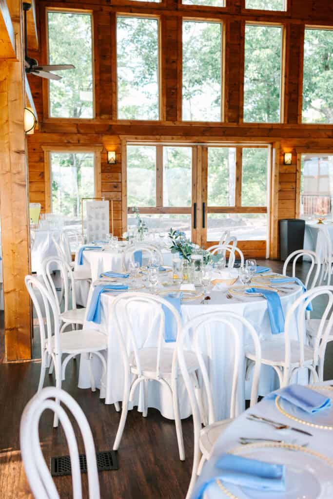 Lauren + Connor Wedding Reception tables arranged near the venue's tall wooden windows