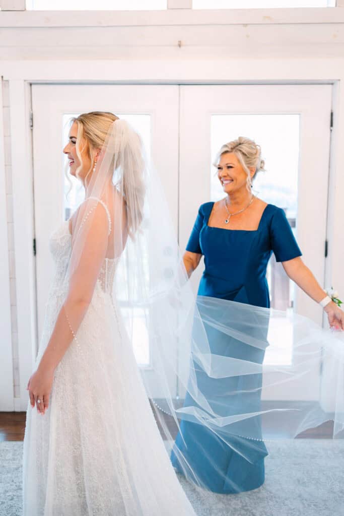Lauren + Connor Wedding Mother holds the veil open behind the bride