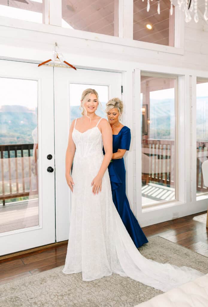 Lauren + Connor Wedding Bride and her mother pose together beside the bright windows
