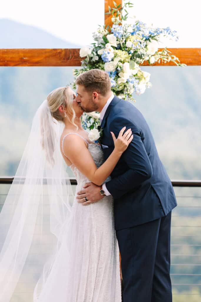 Lauren + Connor Wedding Groom dips the bride for a kiss in the aisle after the ceremony