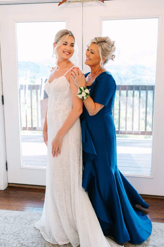 Lauren + Connor Wedding Bride embraces her mother, who wears a navy blue dress